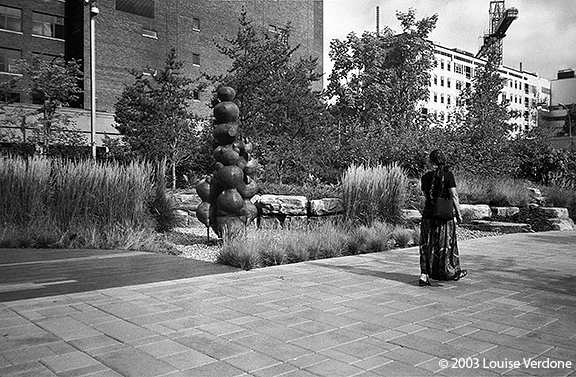 Woman Looking Towards Sculpture