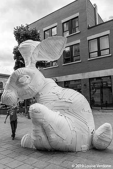 Reaching for the rabbit sculpture