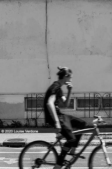 Blurred Cyclist with Hair Bun