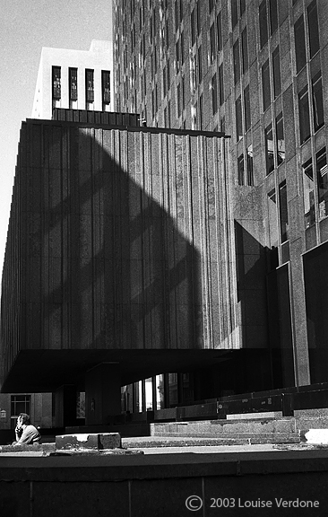 Man Smoking Sitting Around a Building