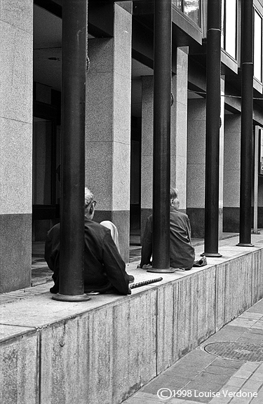 Couple Sitting Around a Building