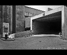 Man Sitting in the Entrance of a Parking