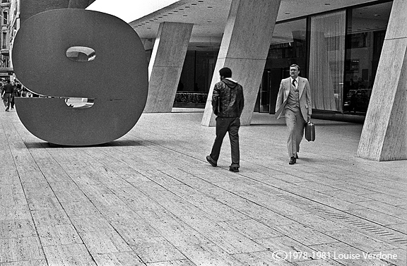 Two Men and a 9 Around a Building