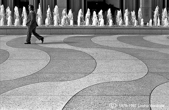 Man, Building Plaza and Fountain